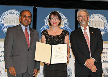 Awardee holding Presidential citation between the Director of the National Science Foundation, Dr. Subra Suresh and the Director of the White House Office of Science and Technology Policy, Dr. John P. Holdren.